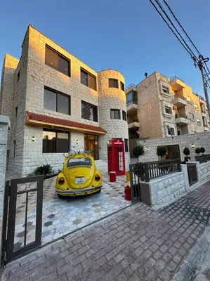 a yellow car parked in front of a building at 8/ Antica jabalal-lwebdeh in Amman