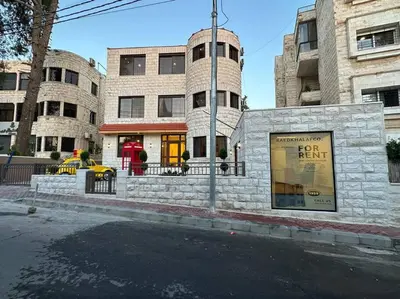 a building on the corner of a city street at X/ Antica jabalal-lwebdeh in Amman