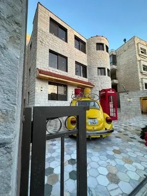 a yellow car parked in front of a building at X/ Antica jabalal-lwebdeh in Amman