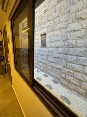 a window in a room with a stone wall at XX/ Antica jabalal-lwebdeh in Amman