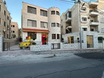 a yellow car parked in front of a building at XX/ Antica jabalal-lwebdeh in Amman