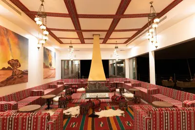 a large room with red chairs and a large statue at Valley Resort in Wadi Rum