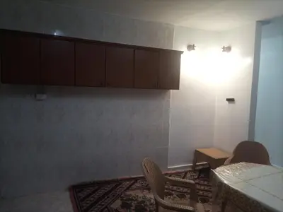a room with a table and chairs and a light at Decapolis with garden in Irbid