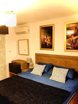a bedroom with a blue bed with two pillows at Royal Luxury Amman Central Apartments in Amman