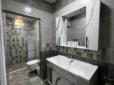 a bathroom with a sink and a toilet at Downtown Inn Madaba in Madaba