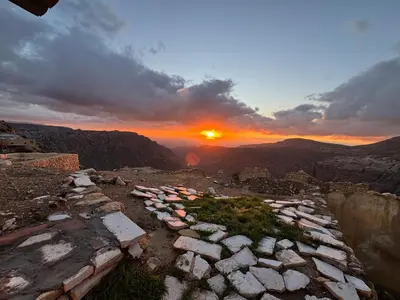 a group of rocks on a mountain with the sunset at Dana Tower Hotel in Dana