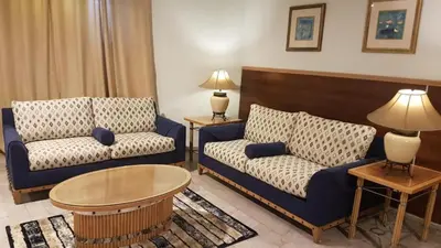 a living room with two couches and a table at Conord Hotel in Amman