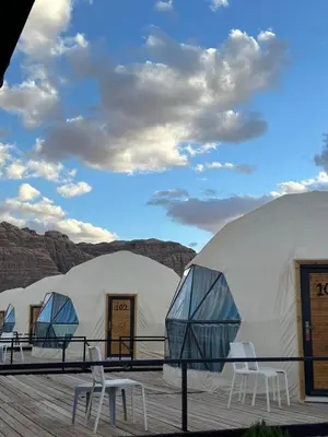 a row of domes with chairs in front of them at Lucas Camp Wadi Rum in Wadi Rum