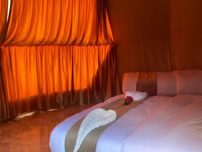 a bedroom with a bed with flowers on it at Lucas Camp Wadi Rum in Wadi Rum