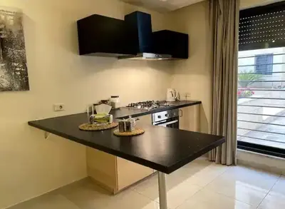 a kitchen with a black counter top and a stove at Luxurious cozy apartment in Amman