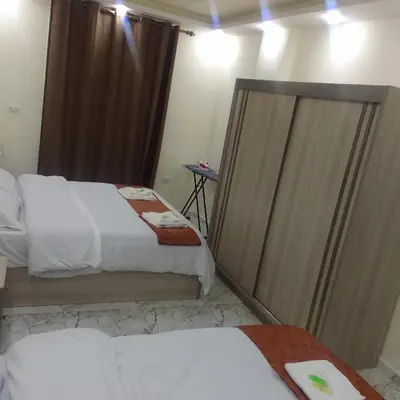 a hotel room with two beds and a mirror at Dream Hotel jerash in Jerash