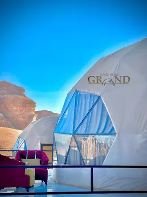 a group of tents with couches in the desert at WADI RuM GRAND in Wadi Rum
