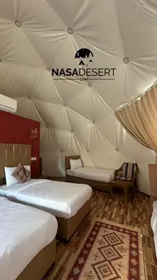 a room with two beds in a tent at Nasa desert luxury camp in Wadi Rum
