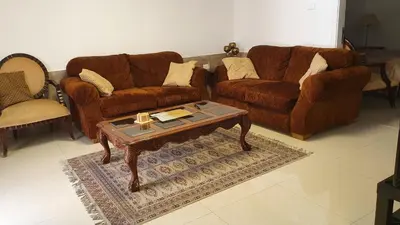 a living room with two couches and a coffee table at ‘C’ DAZZLING MODERN 2 BDRM APT IN KHALDA Free WIFI in Amman