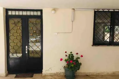 a black door with a potted plant next to a building at ‘C’ DAZZLING MODERN 2 BDRM APT IN KHALDA Free WIFI in Amman