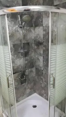 a shower with a glass enclosure in a bathroom at ‘C’ DAZZLING MODERN 2 BDRM APT IN KHALDA Free WIFI in Amman