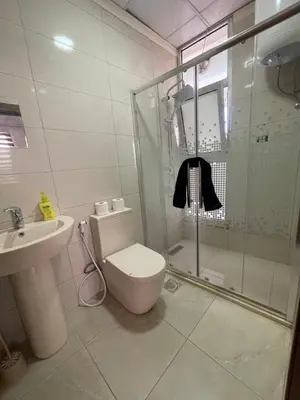 a bathroom with a shower and a toilet and a sink at Apartment for rent 50M fully furnished - in Amman