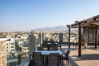 a table and chairs on the roof of a building at My Hotel by Trend in Aqaba