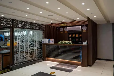 a restaurant with a counter with wine bottles at My Hotel by Trend in Aqaba