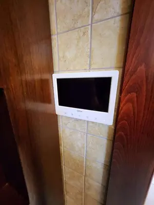 a microwave on the wall of a room at Dair Ghbar - Amman Apartment in Amman