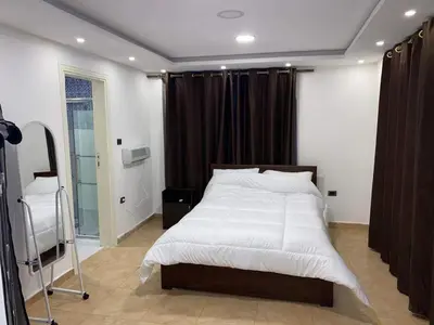 a bedroom with a large bed and a window at The view in Amman