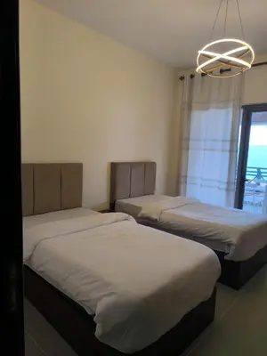 a room with two beds and a chandelier at EP2 Samarah Resort in Sowayma