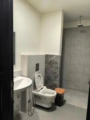a bathroom with a toilet and a sink at EP2 Samarah Resort in Sowayma