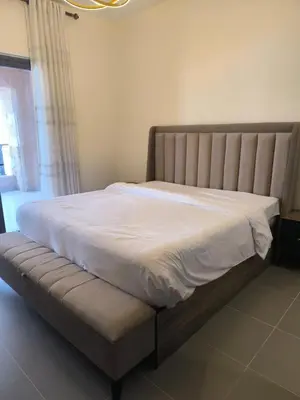 a bed in a bedroom with a white at EP2 Samarah Resort in Sowayma
