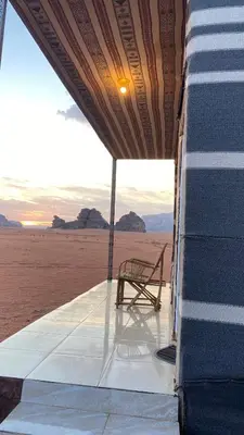a chair sitting on the side of a bus in the desert at nature camp in Wadi Rum