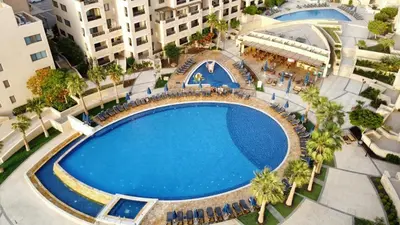 an overhead view of a large swimming pool in a city at E21 Samarah Resort Apartments in Sowayma