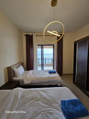 a hotel room with two beds and a chandelier at E13 Samarah Resort Apartment in Sowayma