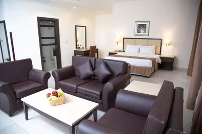 a hotel room with a bed and a living room at East hotel in Sowayma