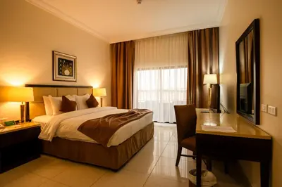 a hotel room with a bed and a desk at East hotel in Sowayma