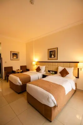 a hotel room with two beds in a room at East hotel in Sowayma