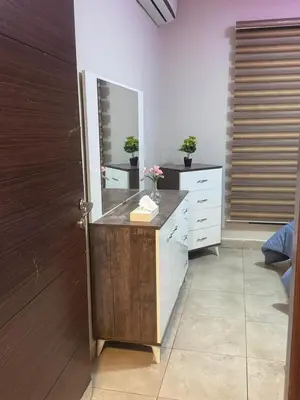 a bathroom with a vanity with a mirror and a dresser at 2 bedrooms apartment no 18 in Amman