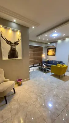 a living room with a painting of a deer on the wall at 2 bedrooms apartment no 18 in Amman