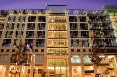 a large building with lights on it at night at The Abdali Boulevard Hotel in Amman