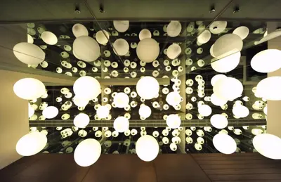 a bunch of white lights hanging from a ceiling at The Abdali Boulevard Hotel in Amman