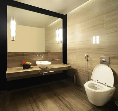 a bathroom with a white toilet and a sink at The Abdali Boulevard Hotel in Amman