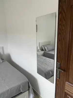 a mirror reflection of a bedroom with two beds at Deadsea Elite First floor shared swimming pool in Sowayma