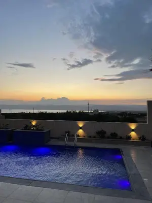 a swimming pool with a sunset in the background at Deadsea Elite First floor shared swimming pool in Sowayma
