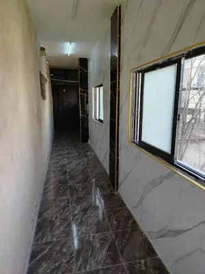 a hallway with a window in a room with a tile floor at الشقة العائلية الحديثة familial new flat in Amman