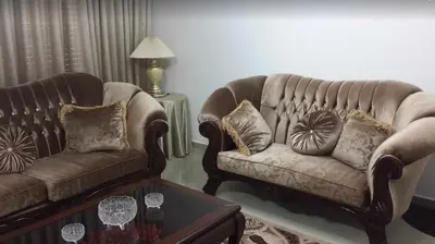 a living room with two couches and a table at Shahed Apartment in Amman