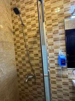 a shower with a shower head in a bathroom at al-burj apart at 7th circle in Amman