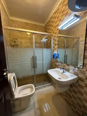 a bathroom with a toilet and a sink at al-burj apart at 7th circle in Amman