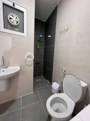 a bathroom with a toilet and a sink at The guset house in Kerak