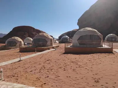 a group of domes in the middle of a desert at Quite bubble tent in Wadi Rum