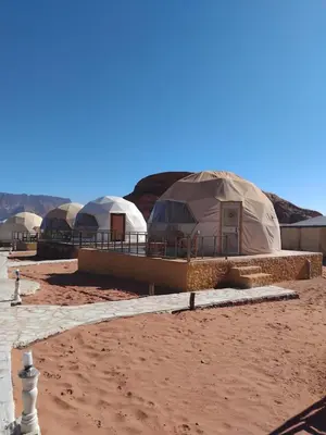 a row of luxury tents in the desert at Quite bubble tent in Wadi Rum