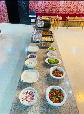 a buffet with bowls of food on a table at Rum Elegant luxury camp in Wadi Rum