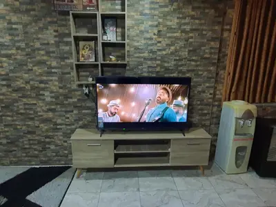 a flat screen tv sitting on top of a dresser at Maria Apartment in Amman